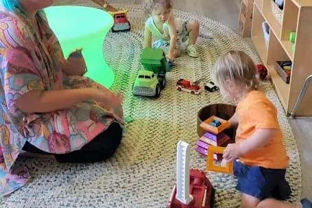 An educator working alongside children at SquareOne Early Learning Center