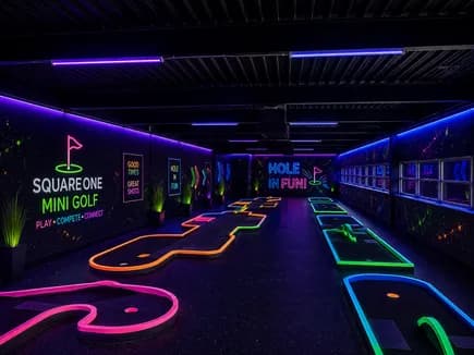 Glow-in-the-dark mini golf course with neon lighting in the Adventure Zone